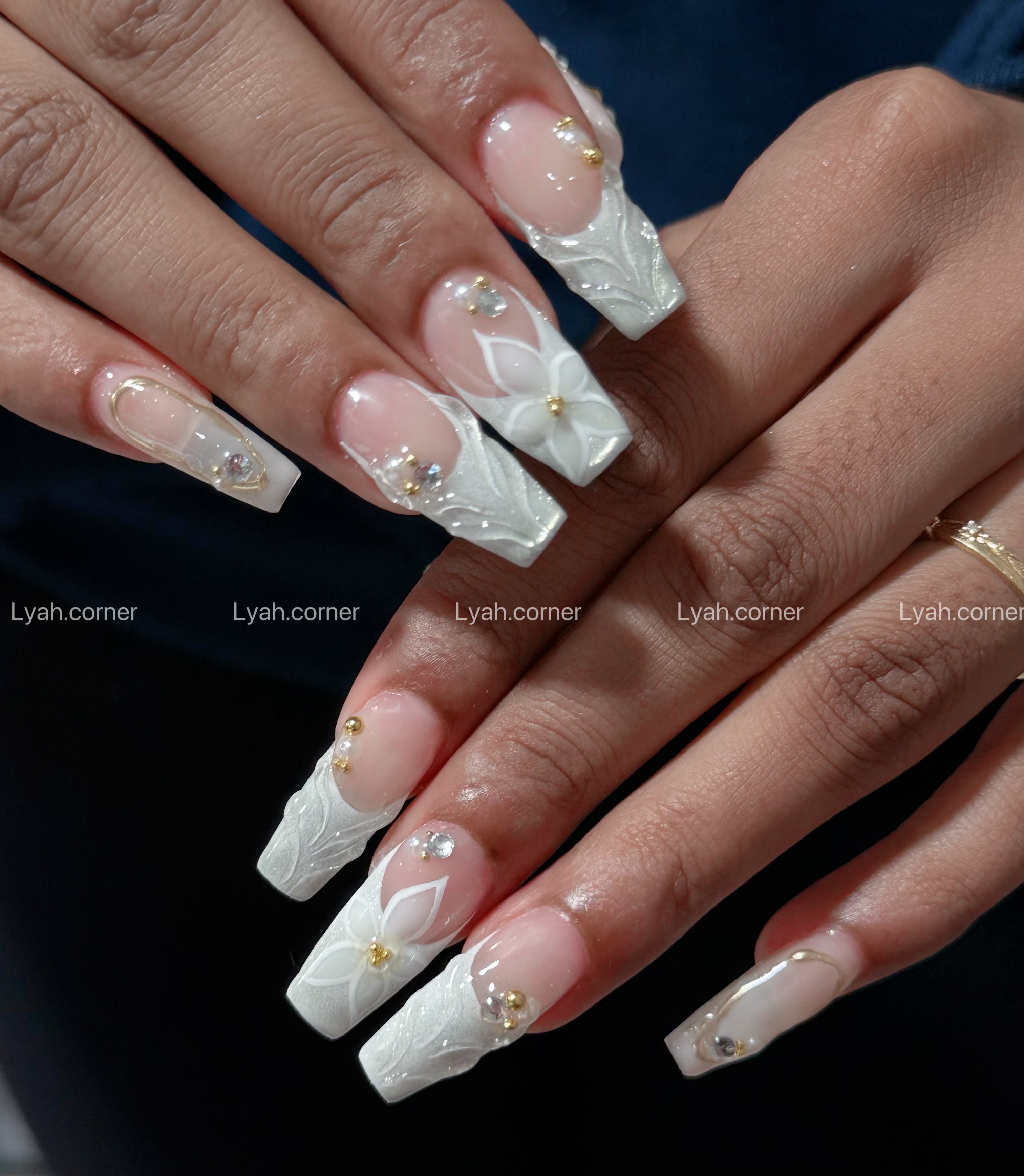 Hand-painted floral nail art on natural nails — Lyah Corner, spring 2026